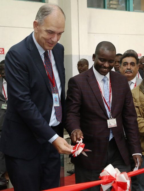 KQ Chief Operating Officer Jan De Vegt (Left) and KQ Ag . General Manager Cargo Mr Peter Musola cut the ribbon during  the launch of six new docking bays at KQ cargo center at JKIA.