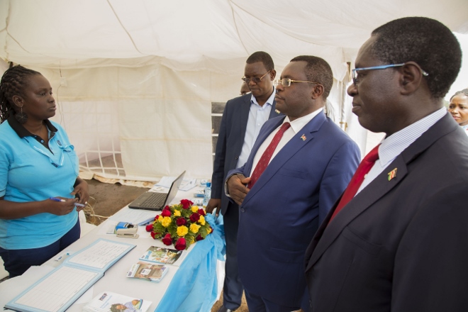 Communications Authority Director General Francis Wangusi and Bungoma Governor Kenneth Lusaka visit the NHIF exhibition stand during the Bungoma ICT education forum dubbed Kikao Kikuu.