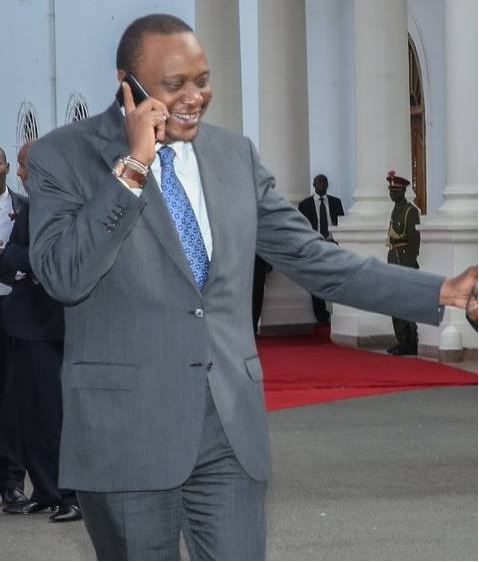 Image result for uhuru kenyatta MAKING PHONE CALLS