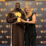A Varkey foundation official poses for a photo with Kenyan teacher Peter Mokaya Tabichi, the winner of this year's Global Teacher Prize www.businesstoday.co.ke