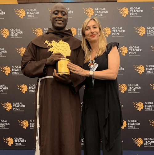 A Varkey foundation official poses for a photo with Kenyan teacher Peter Mokaya Tabichi, the winner of this year's Global Teacher Prize www.businesstoday.co.ke