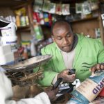 A farmer at an agro shop in Kenya verifies maize seeds before purchase.