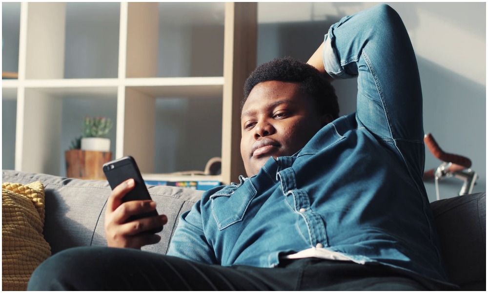 A man using a smart phone. Many Kenyans order goods and services online on various eCommerce platforms.