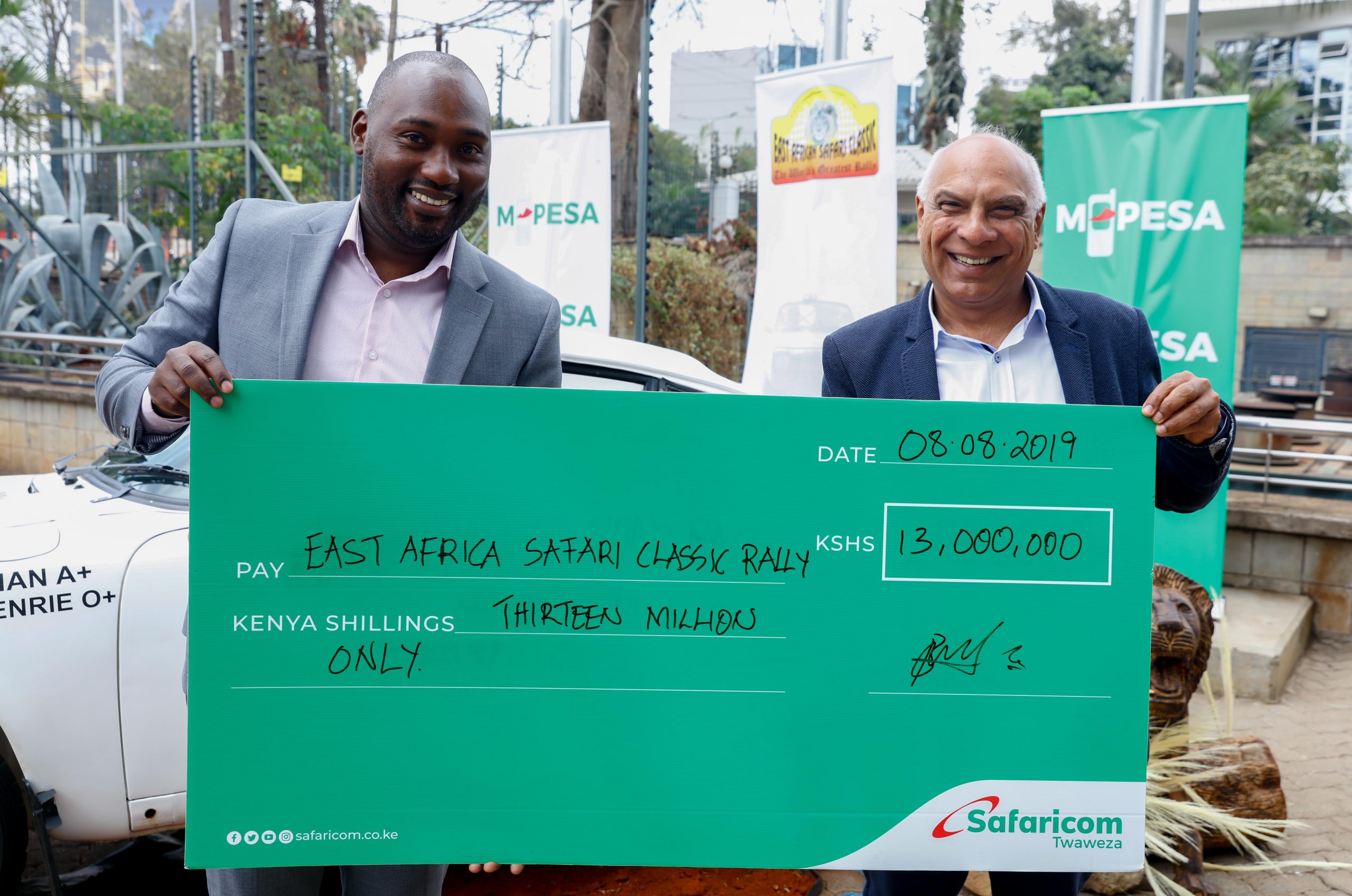 (L to R) M-PESA Products & Services HOD, Boniface Mungania handover a cheque worth Ksh 13Million to Chairman East Africa Safari Classic Rally (EASCR) Raju Kishinani towards the upcoming East Africa Rally. www.businesstoday.co.ke