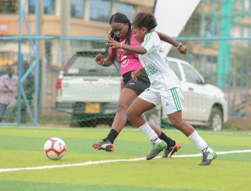 Joy Queenlady of Chapa Dimba All Stars (R) fights for the ball with Safaricom All Stars Beverly Rowa in an opening match during the launch of Chapa Dimba Season Three at Ligi Ndogo grounds www.businesstoday.co.ke