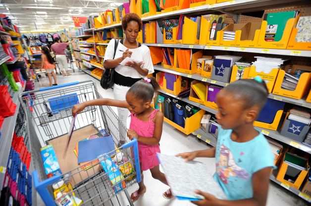 A mother shopping for school items with her daughters www.businesstoday.co.ke