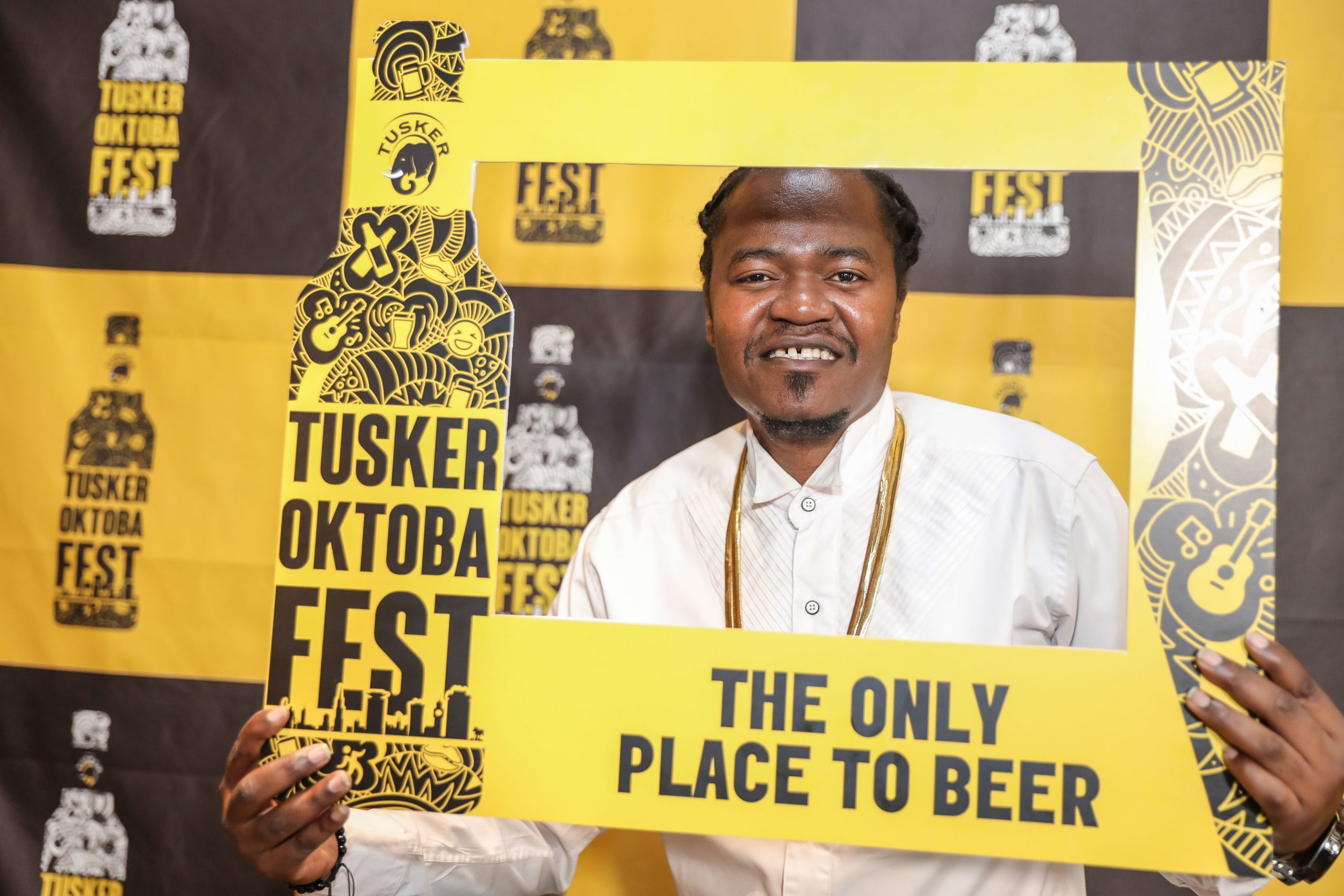 Celebrated Kenyan Kenyan hip hop artist, Juakali Pose with a Tusker Oktoba Fest Frame during the unveil the 2 days Festival held at the Blue Door Beer Garden. www.businesstoday.com