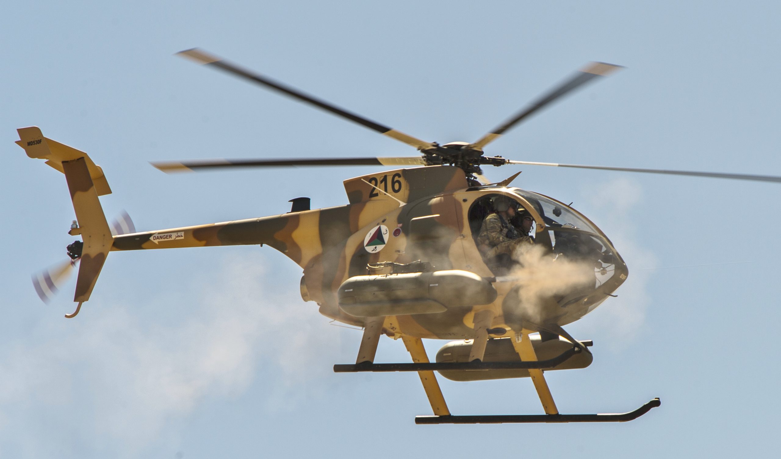Afghan Air Force MD-530F Cayuse Warrior helicopter fires its two FN M3P .50 Cal machine guns during a media demonstration, April 9, 2015, at a training range outside of Kabul, Afghanistan. www.businesstoday.co.ke