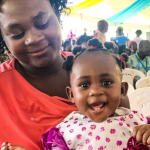 A mother holds her child during the launch of the malaria vaccine phased roll out in Homa Bay County. www.businesstoday.co.ke