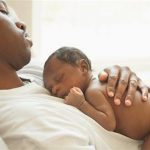 A father holding his new born child www.businesstoday.co.ke
