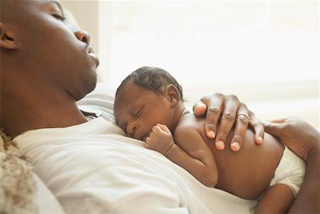 A father holding his new born child www.businesstoday.co.ke