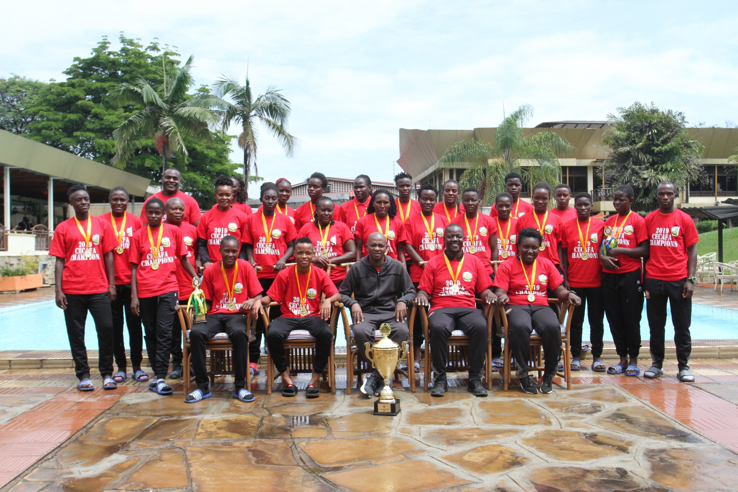 FKF President Nick Mwendwa with the Harambee Starlets squad pose for a picture with the trophy. www.businesstoday.co.ke