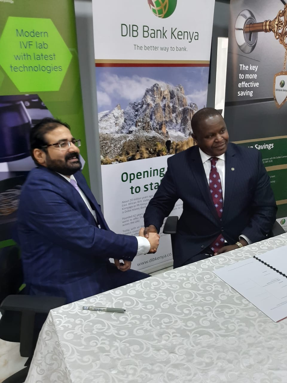NMC Fertility centre's Atul Dureja (left) shakes hands with DIB Bank's Peter Makau after signing the partnership. www.businesstoday.co.ke