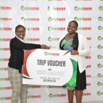 Username Investment Ltd. Marketing Manager left awarding Naom Chelagat right a trip voucher for 2 to Mombasa after she emerged a winner in the recently held Christmas Campaign Draw. www.businesstoday.co.ke
