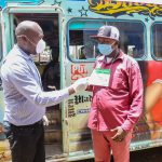 Boniface Mungania(left)Head of M-PESA product Management at Safaricom PLC explains to Simon Maina conductor at Forward Traveler Sacco, how his passengers should pay fare with M-PESA during an awareness campaign.