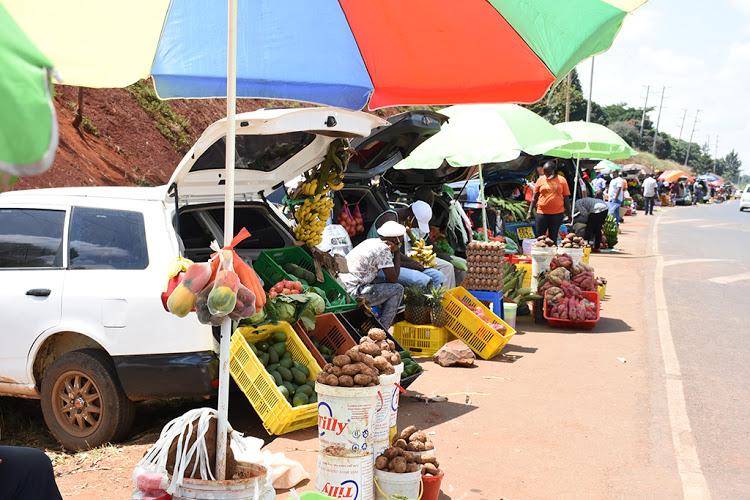 Kenyans pictured selling fruits and vegetables out of their cars