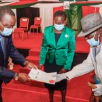 President Uhuru Kenyatta handing over a title deed to a member of the Samburu community as Lands Cabinet Secretary Farida Karoney looks on at a past function.