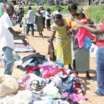Customers look through items at Nairobi's open-air Uhuru Market