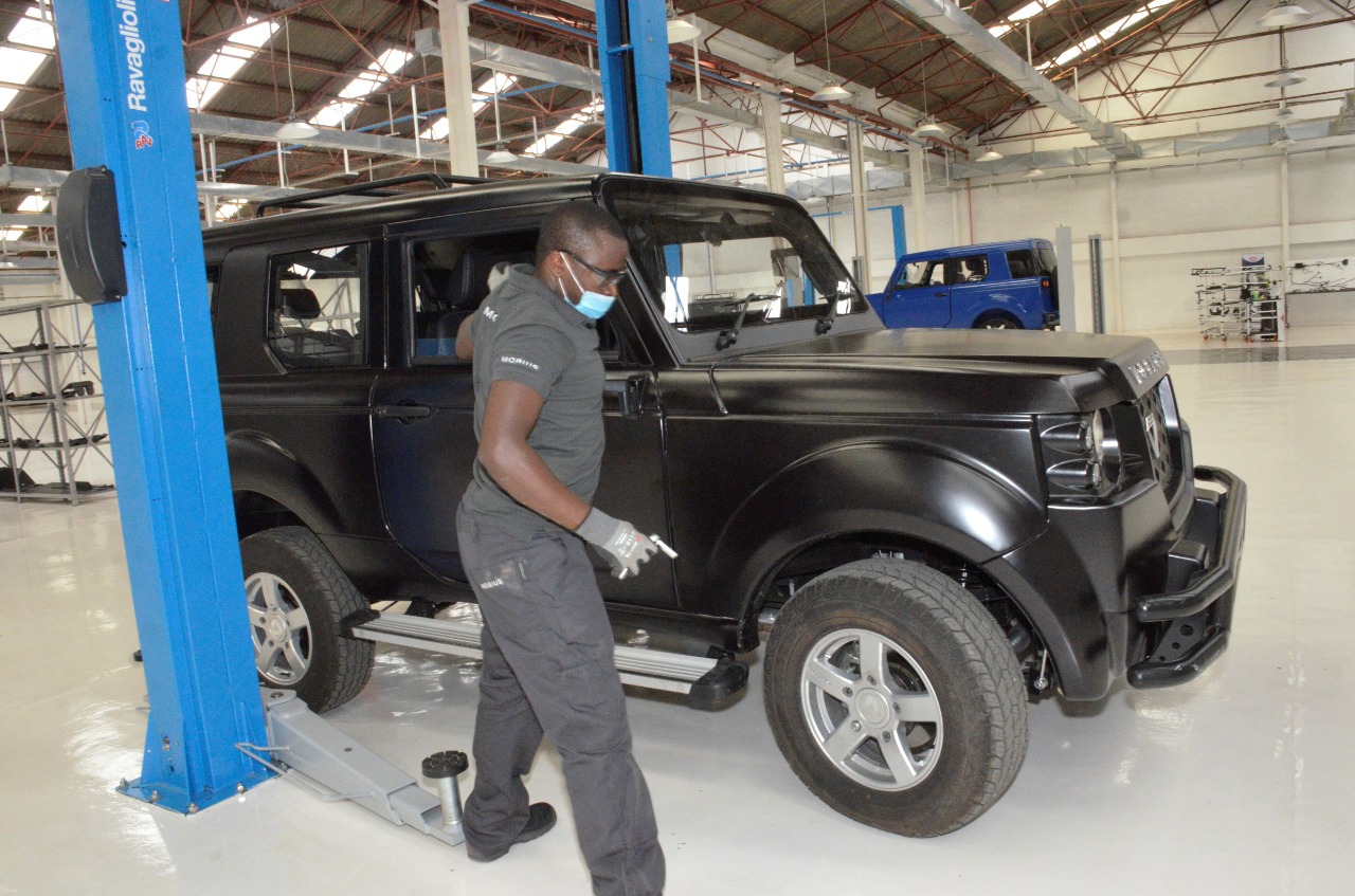 A staff member works on a vehicle at Mobius Motors' new plant in Nairobi
