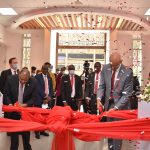 Absa Bank CEO Jeremy Awori (right) and Chairman Charles Muchene cut a ribbon to mark the opening of Absa's Queensway branch in Nairobi on February 10, 2021