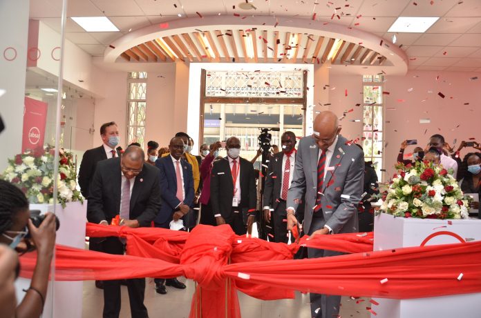 Absa Bank CEO Jeremy Awori (right) and Chairman Charles Muchene cut a ribbon to mark the opening of Absa's Queensway branch in Nairobi on February 10, 2021