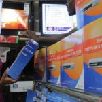 A customer looks through StarTimes decoders at a retail outlet.