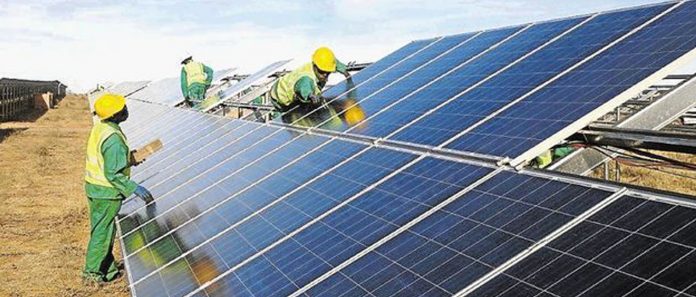 Technicials installing solar panels in Kenya
