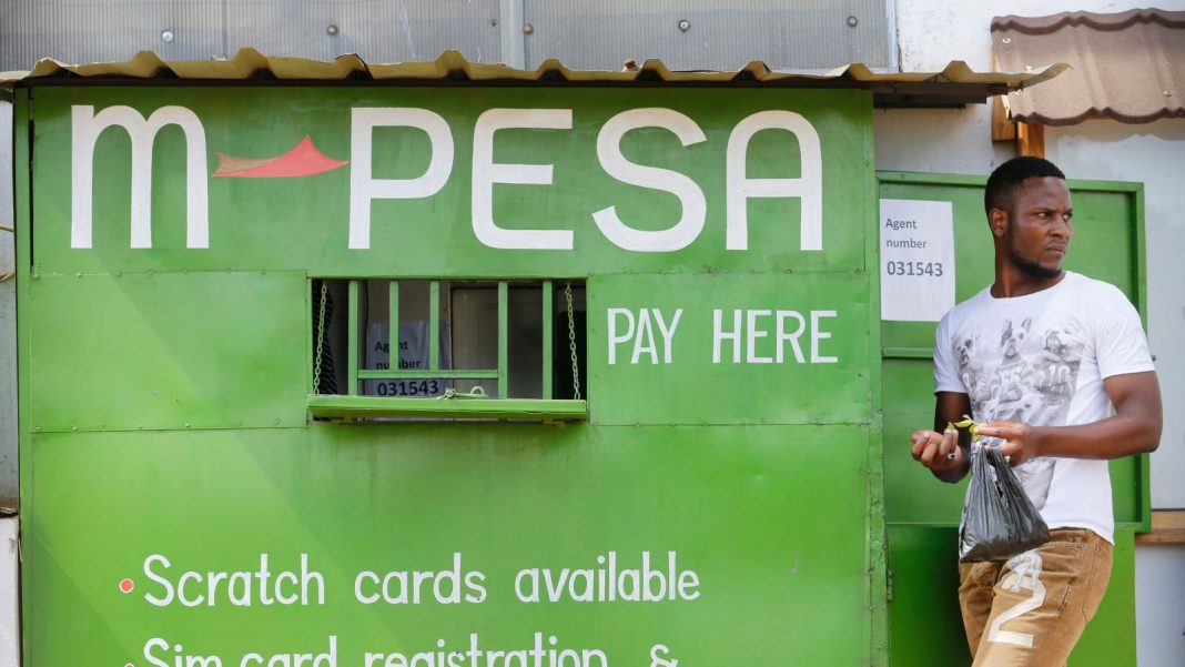 A man walks by an M-Pesa agent outlet in Nairobi. Calls are growing for M-Pesa agents to be recognized as Safaricom employees.
