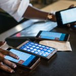 A person using multiple smart phones at the same time. The cost of transactions on mobile money services such as M-Pesa has many Kenyans looking for cheaper ways to send money and make payments.