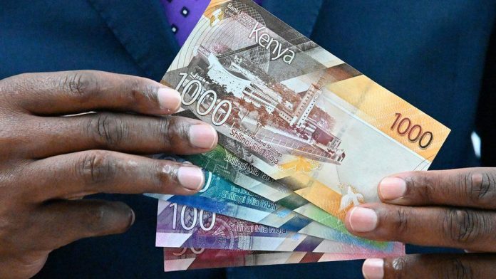 n A man holding up Kenyan bank notes. The government is considering introducing a Wealth Tax to shore up revenues.