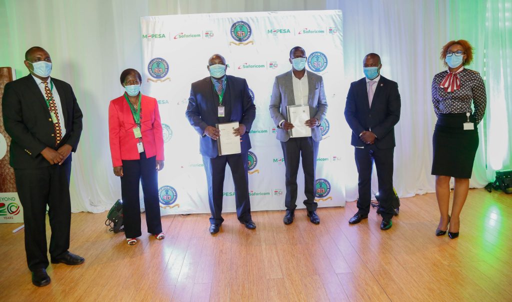 Safaricom and HELB officials pose after unveiling a partnership on March 2, 2021