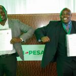 Safaricom Chief Financial Services Offier Sitoyo Lopokoiyit with Higher Educations Loans Board (HELB) CEO Charles Ringera after unveiling a partnership on March 2, 2021.