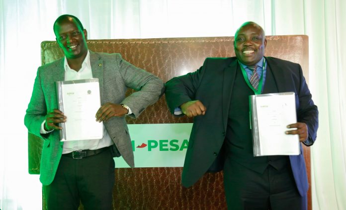 Safaricom Chief Financial Services Offier Sitoyo Lopokoiyit with Higher Educations Loans Board (HELB) CEO Charles Ringera after unveiling a partnership on March 2, 2021.