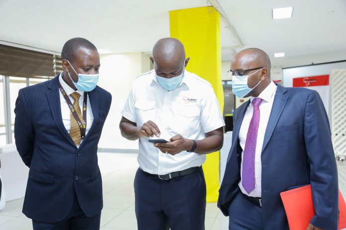 IMAGE -1 The Managing Director of National Bank of Kenya, Paul Russo (right) with Amref Flying Doctors CEO, Stephen Gitau during the launch of Maisha Cover Emergency Service in partnership with Amref Flying Doctors. Looking on is NBK's Head of Change Management, Fred Kioko.
