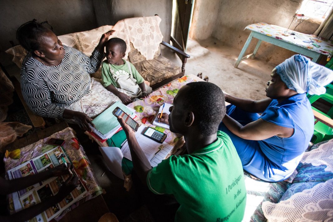 Residents in a rural area using smartphones. One of the countermeasures to address rural decline is for tech companies to recognise that talent can operate from anywhere and provide employees the option of working from anywhere. (Photo: OneAcre Fund)