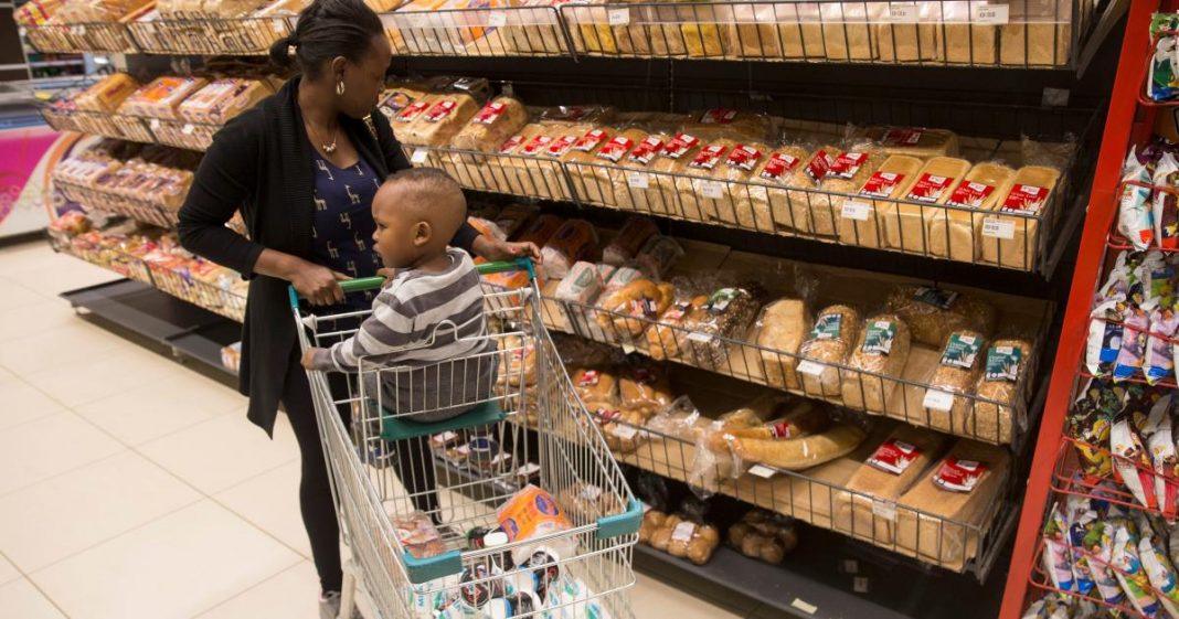 A shopper looks at bread at a supermarket. Several bread manufacturers have been found violating numerous regulatory standards following an investigation by the Competition Authority of Kenya (CAK).