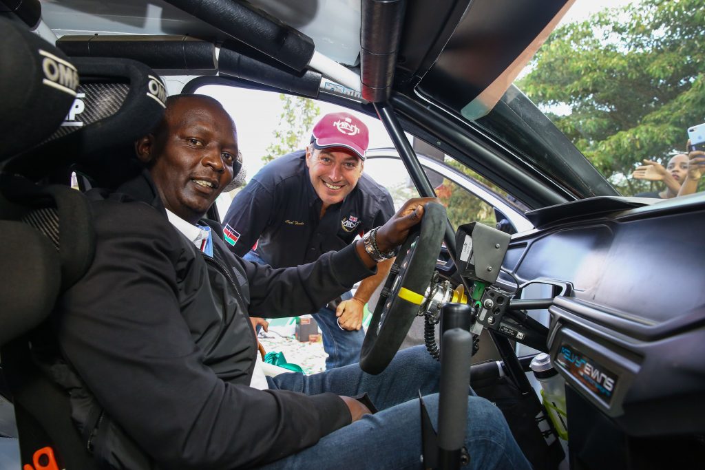 Equator African Rally Championship (ARC) winner, Carl Tundo (RIGHT) gives Safaricom PLC, Chief Financial Service officer, Sitoyo Lopokoiyit (LEFT) a tour of the interior part of his rally car during the Safaricom WRC sponsorship of Carl Tundo in Naivasha.