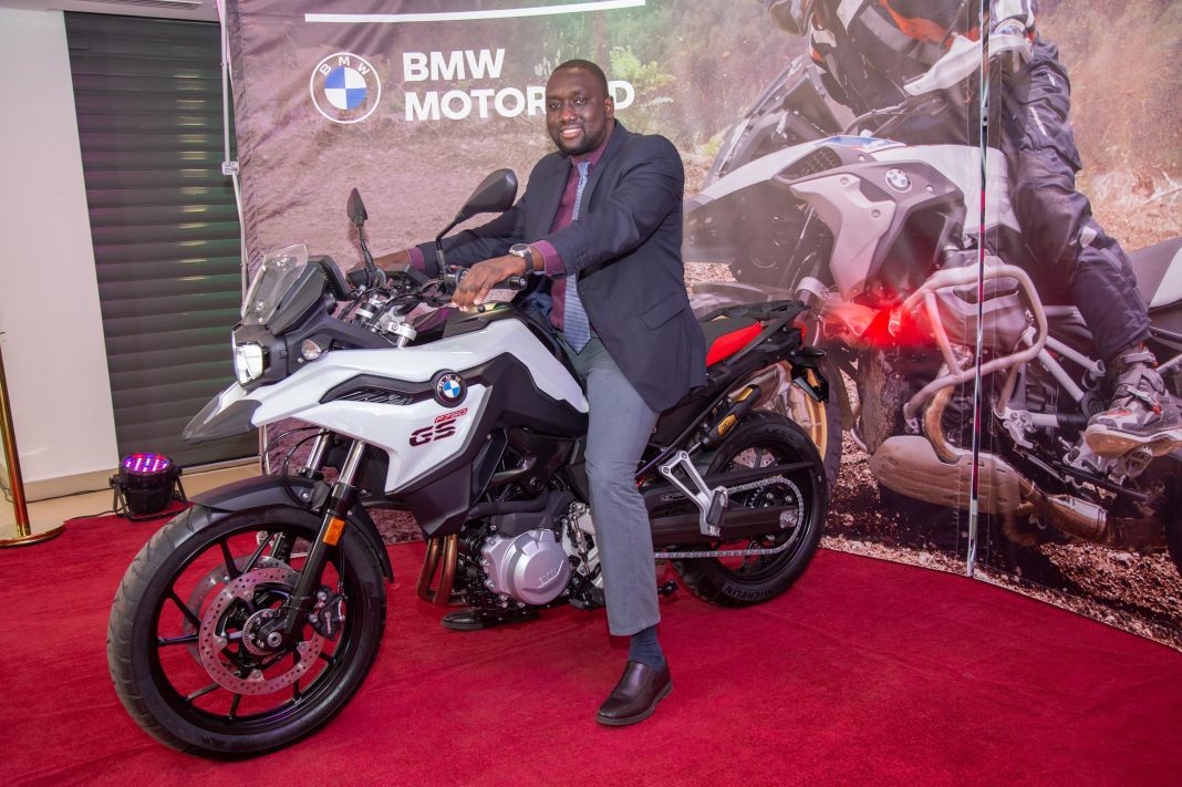 Inchcape Kenya Ltd MD Hussein Ibrahim with a BMW motorbike during the launch of the BMW Motorrad showroom