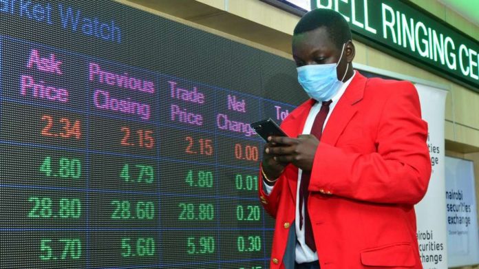 Securities trader Joram Ongura at Nairobi Securities Exchange (NSE) trading floor at the Exchange building in Nairobi on August 26, 2020. The NSE 20 Share Index - a price weighted index calculated as a mean of the top 20 best performing counters - fell by 29.6 per cent in 2020. [Photo: SALATON NJAU (NAIROBI)]