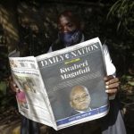 A man in Nairobi reads the Daily Nation on March 18, 2021. Print which has been NMG's traditional cash cow continued its recovery from the pandemic induced decline of 2020 in the first half of 2021. [Photo/ AP Photo/Khalil Senosi]