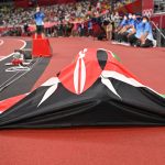 Draped in the Kenyan flag, Faith Kipyegon soaks in the moment after winning Gold in the Women's 1500m race on August 6, 2021 at the Tokyo Olympic games. Many Kenyan-born athletes represent different countries for various reasons. [Photo/ @Olympics]
