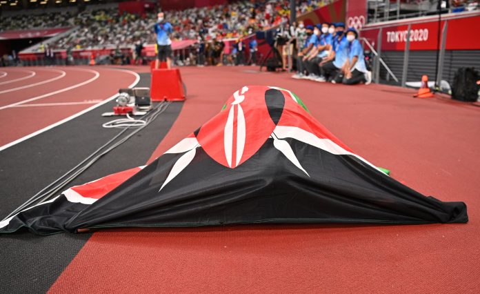 Draped in the Kenyan flag, Faith Kipyegon soaks in the moment after winning Gold in the Women's 1500m race on August 6, 2021 at the Tokyo Olympic games. Many Kenyan-born athletes represent different countries for various reasons. [Photo/ @Olympics]