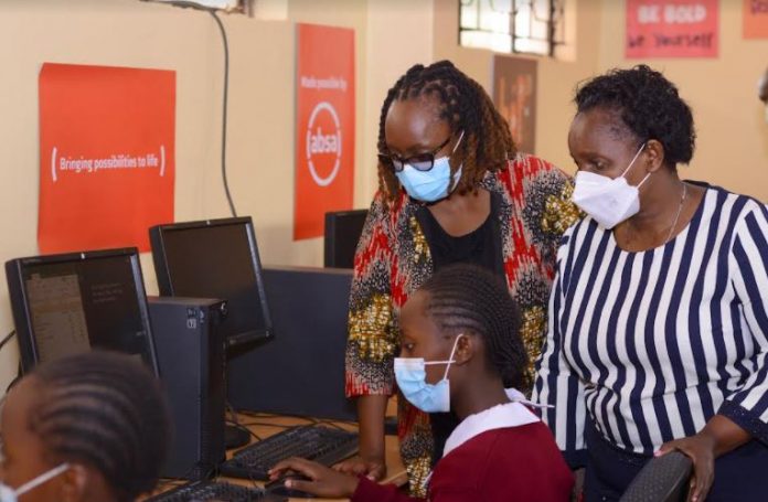 Absa Bank Absa’s Head of Sustainability and Citizenship Ms. Jane Waiyaki and Kikuyu Township Primary School Head Teacher Mrs. Lucy Gitonga interact with students at the school’s newly furnished computer lab.
