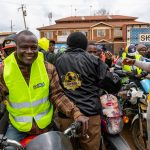 Betika - BodaBoda teams receiving reflector from Education CAS Zack Kinuthia