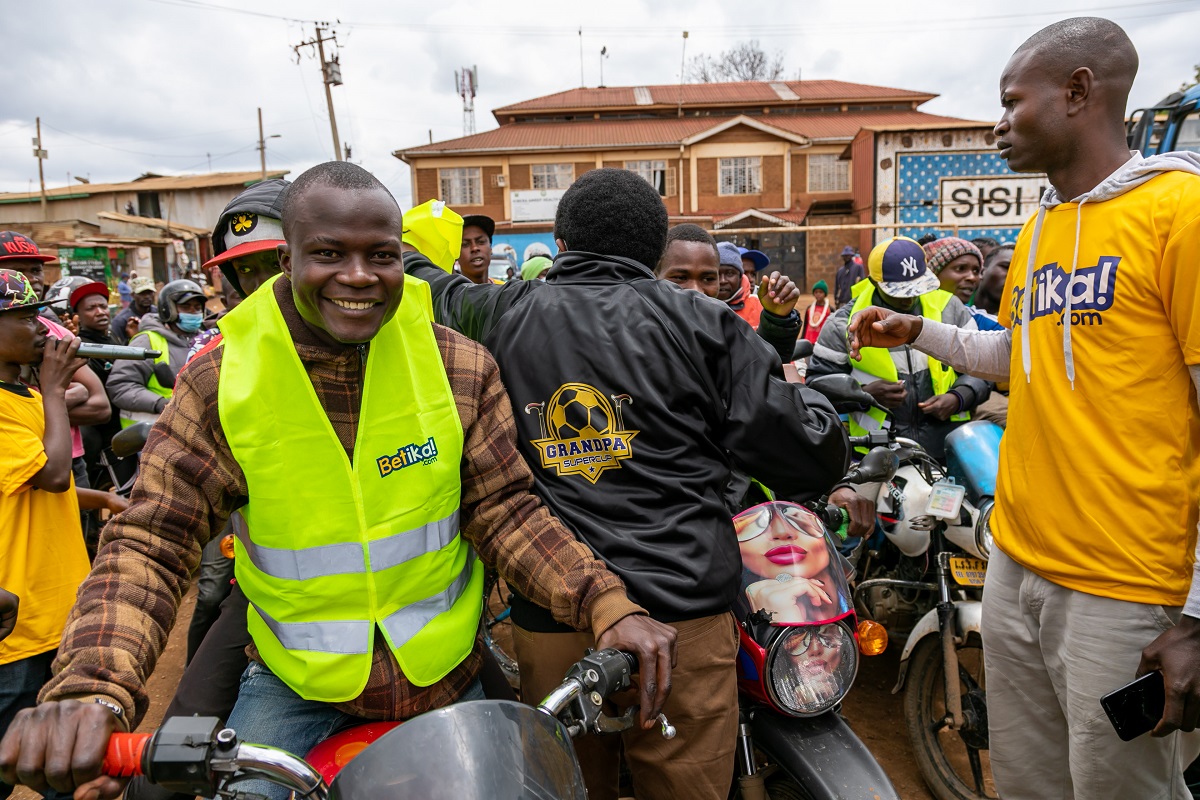 Betika - BodaBoda teams receiving reflector from Education CAS Zack Kinuthia