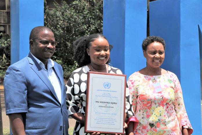 Wawira Njiru flanked by her parents after receiving the 2021 UN Person of the Year Award in Nairobi on October 25, 2021. [Photo/ UN Kenya]