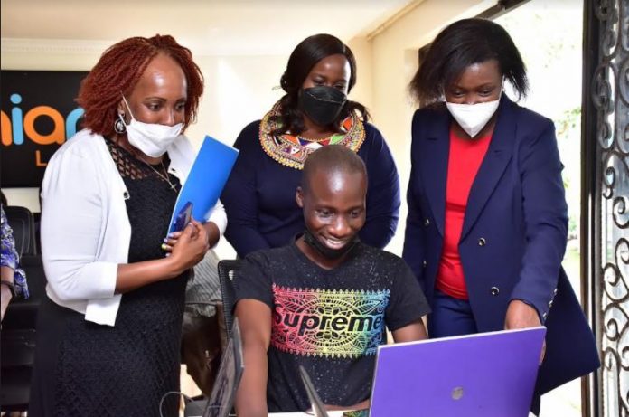 An animation student Benon Nyabuto showcases his project to Family Group Foundation Director Annie Muya,CEO&Co-Founder Ada Animation Joy Mwangi& Family Bank CEO Rebecca Mbithi.The Bank has partnered with Adanian Lab t