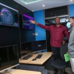 Dimension Data East and West Head of Managed Security Services Dr. Bright Mawudor (left) shows a journalist how the company monitors cyber security threats for businesses at their Threat Intelligence Centre during a media briefing at the firm’s offices in Nairobi.