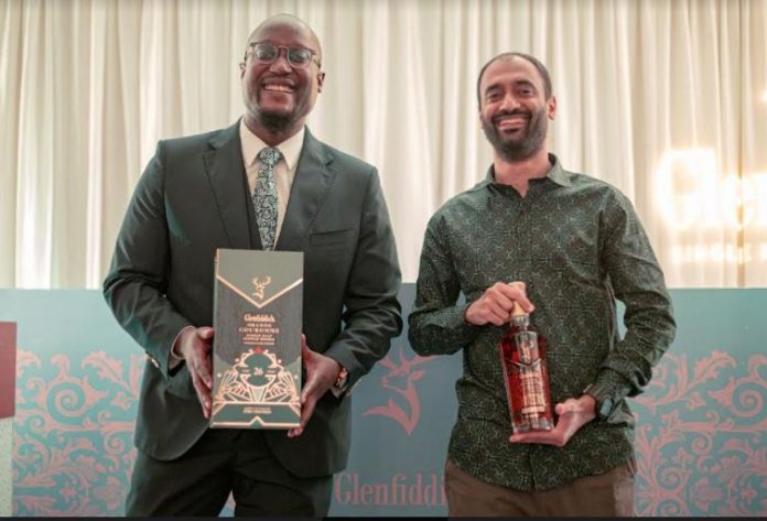 Glenfiddich Brand Ambassador for Kenya Mr. Mulunda Kombo ( Left ) with Kenyan street artist and muralist WiseTwo (Bhupendra Jethwa), showing off the Glenfiddich’s newest addition to the Grand Series, Grande Couronne during the launch event at the Hemingway’s hotel, Nairobi.