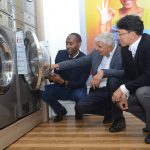 (L-R) Brian Gacheru CEO Pristine Linen & Laundry Ltd, Shailesh Kanani MD Hotpoint Appliances Ltd and LG East Africa Home Appliances Product Manager Mr. Eden Seo during the launch of a new smart laundry shop at the Thika Road Mall (TRM) in Nairobi. LG will partner with vendors and local entrepreneurs to roll out commercial machine reference stores as it seeks to tap into the fast-growing on-demand laundry market in East Africa.